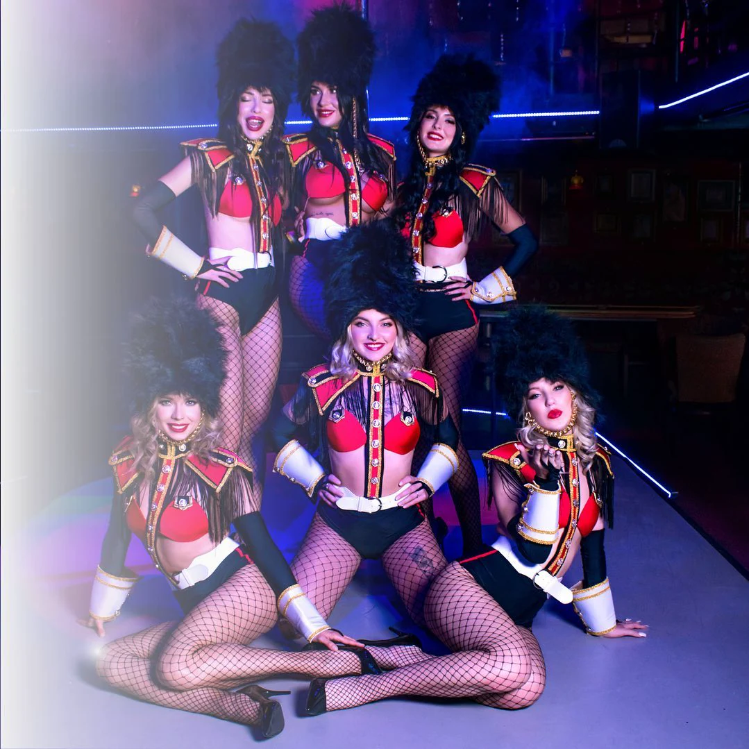 Darling cabaret performers in red show costumes